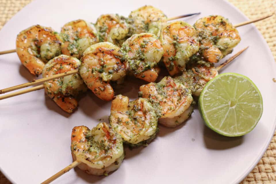 Finished grilled shrimp skewers with Fresh Lime Chimichurri Sauce.