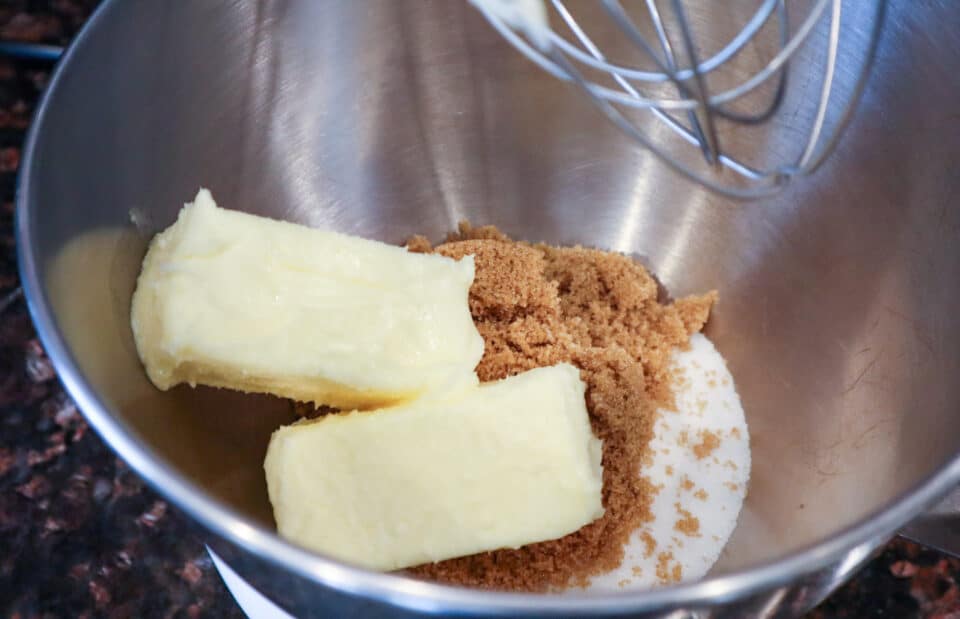 Butter and sugars in a mixing bowl before mixing.