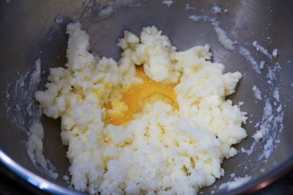 Addition of eggs to the beaten butter and sugar mixture.