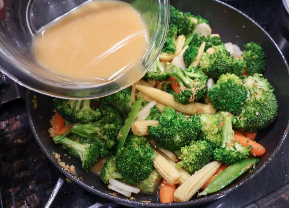 Adding the stir fry sauce to the skillet