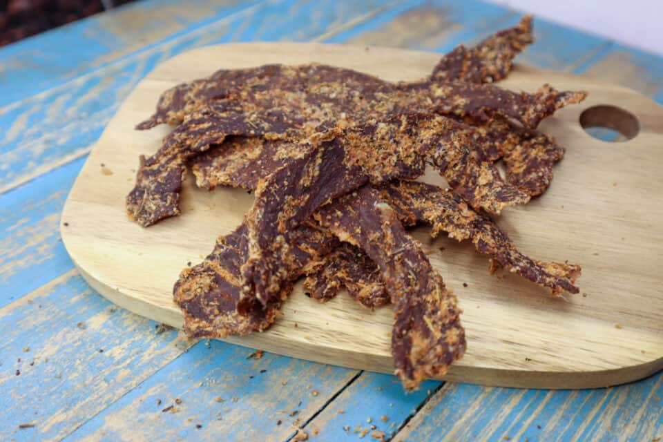 Finished Horseradish & Herb Beef Jerky on a board.