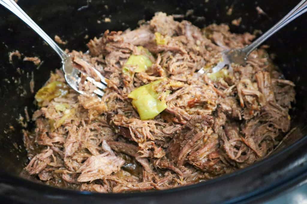 Mississippi Pot Roast being shredded with two forks.