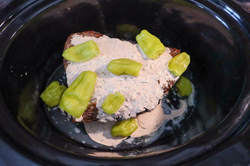 Roast in the slow cooker, covered in the ranch sauce with pepperoncinis on top and alongside. 